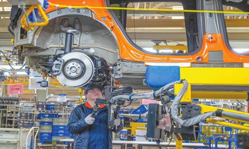 A worker makes a high-end new-energy vehicle on a digital production line at Geely's Changxing base on March 12, 2025 in Huzhou, East China's Zhejiang Province. The production line integrates 5G with the Industrial Internet and a car comes off the line every minute, according to media reports. Photo: VCG