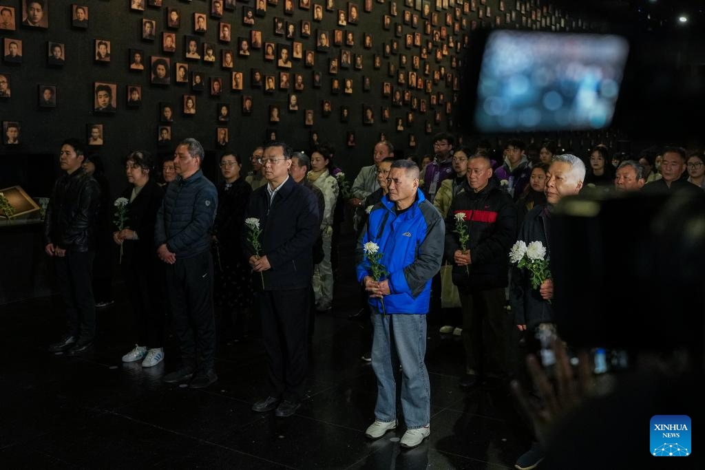 People attend a lights out mourning ceremony held at the Memorial Hall of the Victims in Nanjing Massacre by Japanese Invaders, in Nanjing, east China's Jiangsu Province, March 11, 2025. A lights out mourning ceremony for four survivors of the Nanjing Massacre who passed away this year was held Tuesday in Nanjing. Two survivors of the Nanjing Massacre passed away on Feb. 15 this year, bringing the number of living registered survivors to 28, according to the Memorial Hall of the Victims in Nanjing Massacre by Japanese Invaders. (Photo: Xinhua)