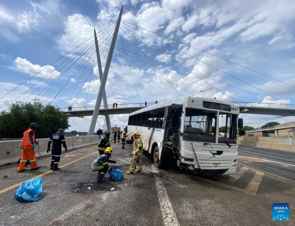 This photo taken with a mobile phone shows staff members cleaning the site of a bus accident in South Africa's northeastern Gauteng Province on March 11, 2025. At least 12 people were killed and 45 others injured on Tuesday morning after a bus overturned in South Africa's northeastern Gauteng Province. (Photo: Xinhua)