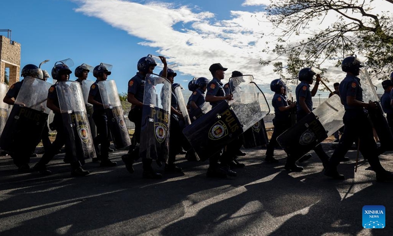 Policemen gather to secure the area where former Philippine President Rodrigo Duterte is being held in the Villamor Airbase in Pasay City, Metro Manila, the Philippines, March 11, 2025. The Philippine Presidential Communications Office (PCO) issued a statement on Tuesday, confirming that former President Rodrigo Duterte was detained by police upon his return to Manila from abroad. (Photo: Xinhua)