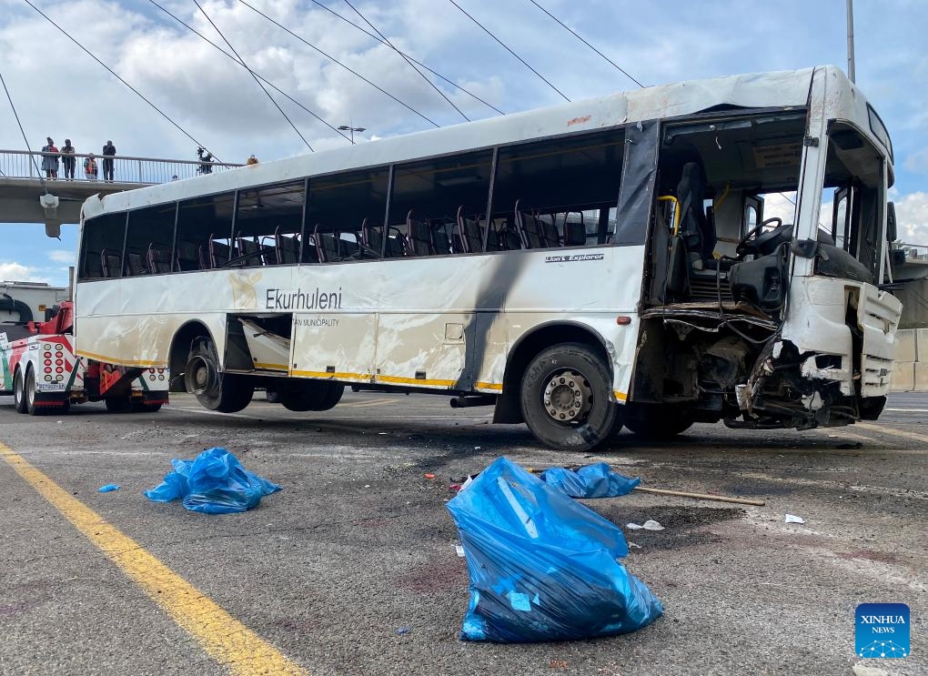 This photo taken with a mobile phone shows staff members cleaning the site of a bus accident in South Africa's northeastern Gauteng Province on March 11, 2025. At least 12 people were killed and 45 others injured on Tuesday morning after a bus overturned in South Africa's northeastern Gauteng Province. (Photo: Xinhua)