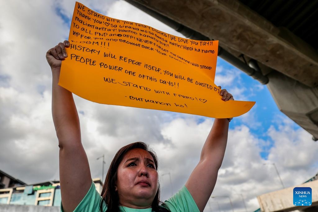 A woman holds a placard to show her support for former Philippine President Rodrigo Duterte in front of the Villamor Airbase in Pasay City, Metro Manila, the Philippines, March 11, 2025. The Philippine Presidential Communications Office (PCO) issued a statement on Tuesday, confirming that former President Rodrigo Duterte was detained by police upon his return to Manila from abroad. (Photo: Xinhua)
