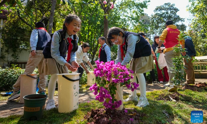 Pupils water bougainvillea in Panlong District of Kunming, southwest China's Yunnan Province, March 11, 2025. From top leaders to ordinary citizens, planting trees has been a prevalent practice for the Chinese. People are also encouraged to adopt or nurture trees, donate money, and conduct volunteer work related to afforestation. The country established National Tree Planting Day on March 12, 1979. (Photo: Xinhua)