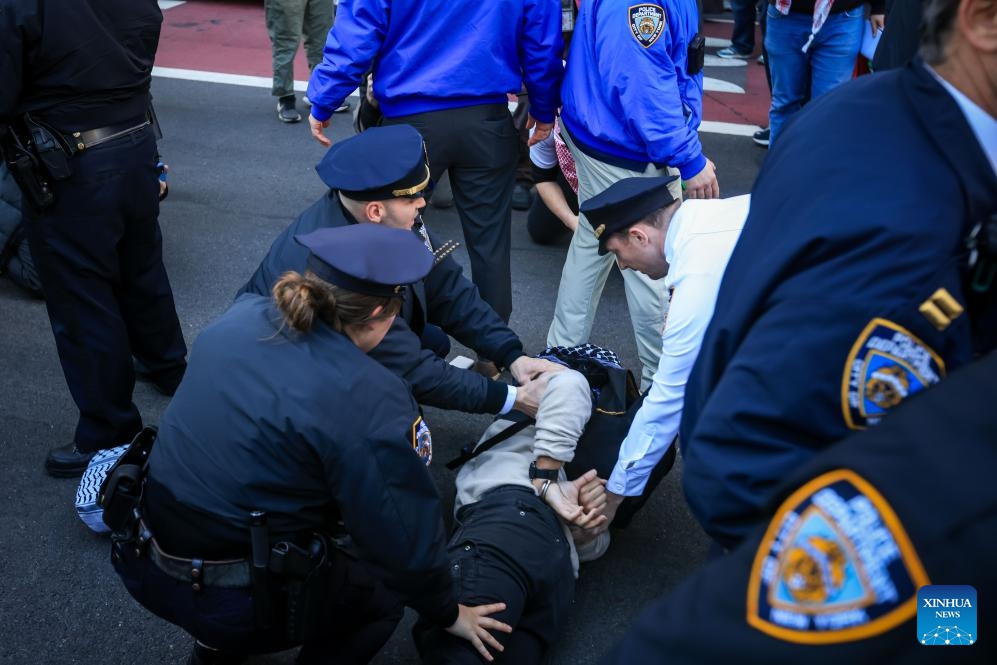 New York Police Department (NYPD) officers arrest a demonstrator during a protest against the Donald Trump administration's policies on the Middle East, campus protests and immigration in New York City, the United States, March 11, 2025. (Photo: Xinhua)
