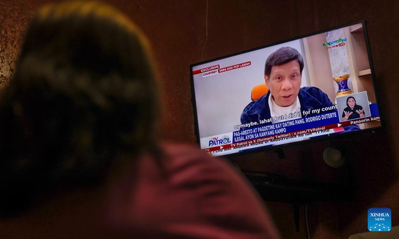 A woman watches the news about former Philippine President Rodrigo Duterte in Quezon City, the Philippines, March 12, 2025. (Photo: Xinhua)