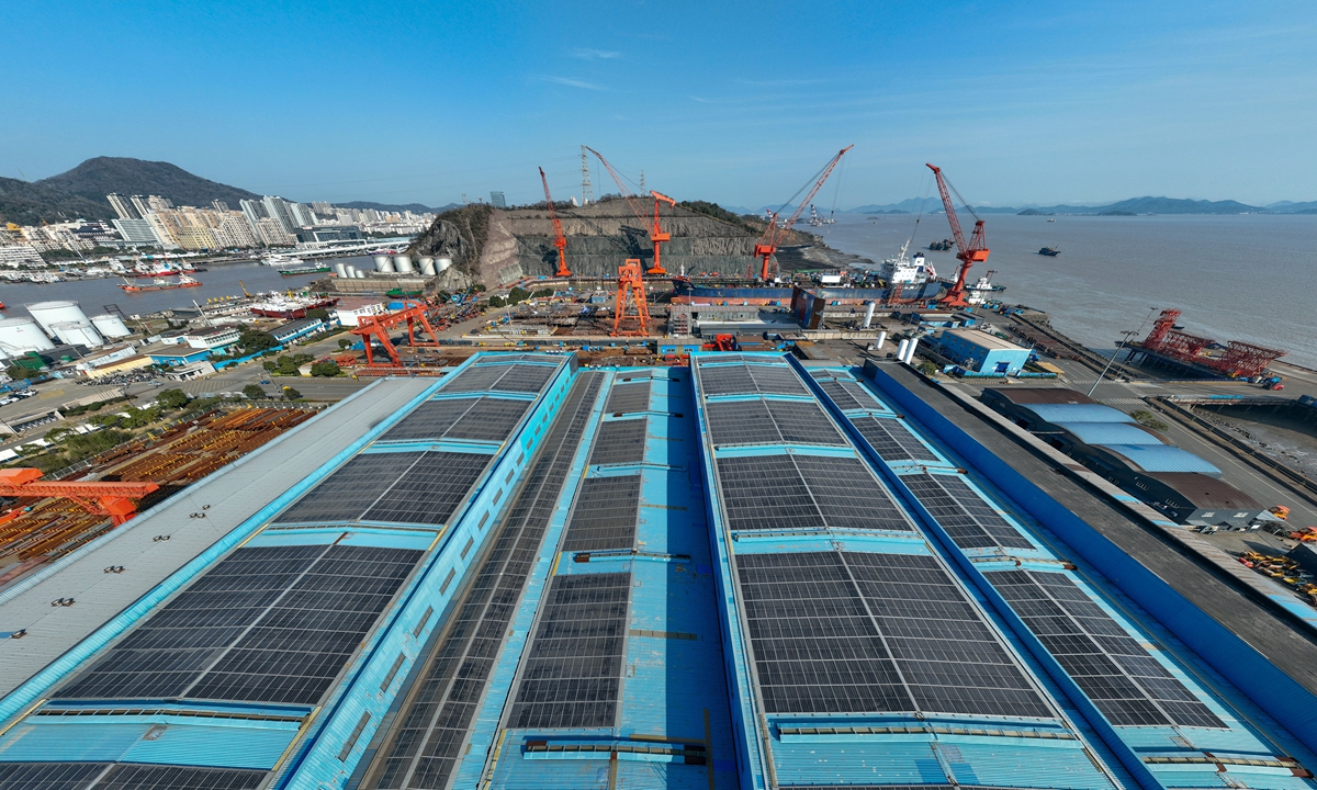 Photovoltaic panels are neatly arranged on the rooftops of ship repair enterprises in Zhoushan, East China's Zhejiang Province, on March 16, 2025. These renewable energy devices generate green energy, helping businesses save energy, reduce emissions and promote green, low-carbon development. China is set to add more than 200 million kilowatts of new-energy power generation capacity in 2025, per the National Energy Administration. Photo: VCG