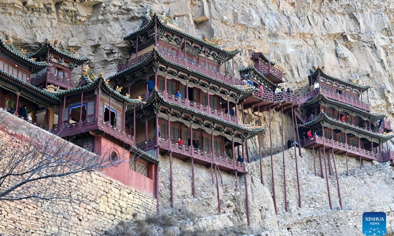 This photo taken on Feb. 28, 2025 shows the Hanging Temple, or Xuankong Temple, in Hunyuan County, Datong City in north China's Shanxi Province. Built over 1,500 years ago, the temple is notable for its location on a sheer precipice. The structure is kept in place with wooden beams inserted into holes chiseled into the cliffs. The main supportive structure is hidden inside the bedrock. The temple is located in a deep valley, and the body of the building hangs from the side of a cliff under a prominent peak, protecting the temple from rain erosion and sunlight. (Photo: Xinhua)