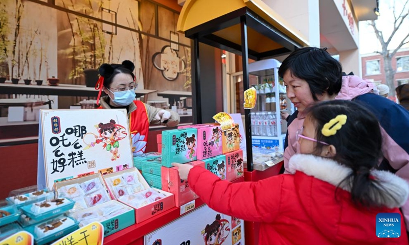 Visitors select pastries at Nezha town in north China's Tianjin, March 16, 2025. Recently, Nezha town in Tianjin hosts a cultural week event, featuring a range of activities centered around the theme of Nezha and other traditional cultural elements. The event included performances, interactive parades, and lantern night tours, offering visitors an immersive cultural experience. Originally the site of the Tianjin Bohai Radio Factory, Nezha town has undergone a transformation as part of Tianjin's urban renewal initiatives. (Photo: Xinhua)