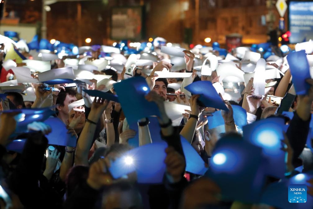 Participants hold placards lightened with their phones during a pro-European rally in Bucharest, Romania, March 15, 2025. (Photo: Xinhua)