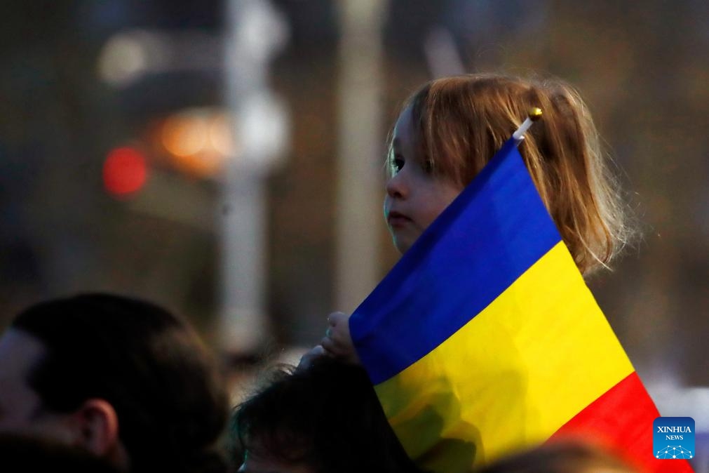 A child holding the Romanian national flag attends a pro-European rally in Bucharest, Romania, March 15, 2025. (Photo: Xinhua)