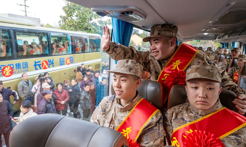 Recruits in military uniform wave goodbye to their families  in Huzhou, East China's Zhejiang Province, on March 18, 2025, before they go to different parts of the country for their military trainings. Photo: VCG
