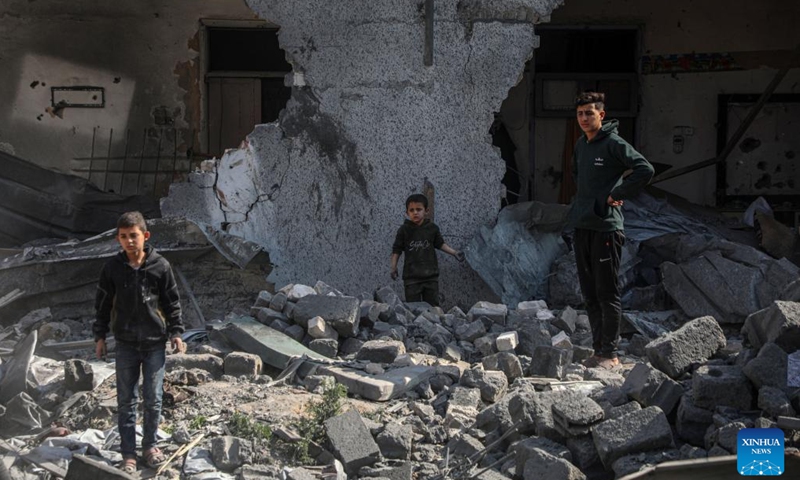 People check the damage of a building in the Shuja'iyya neighborhood, east of Gaza City, on March 18, 2025. The Palestinian death toll from Israeli airstrikes across the enclave early Tuesday has risen to 413, Gaza health authorities reported, adding women and children were among those killed. (Photo by Rizek Abdeljawad/Xinhua)