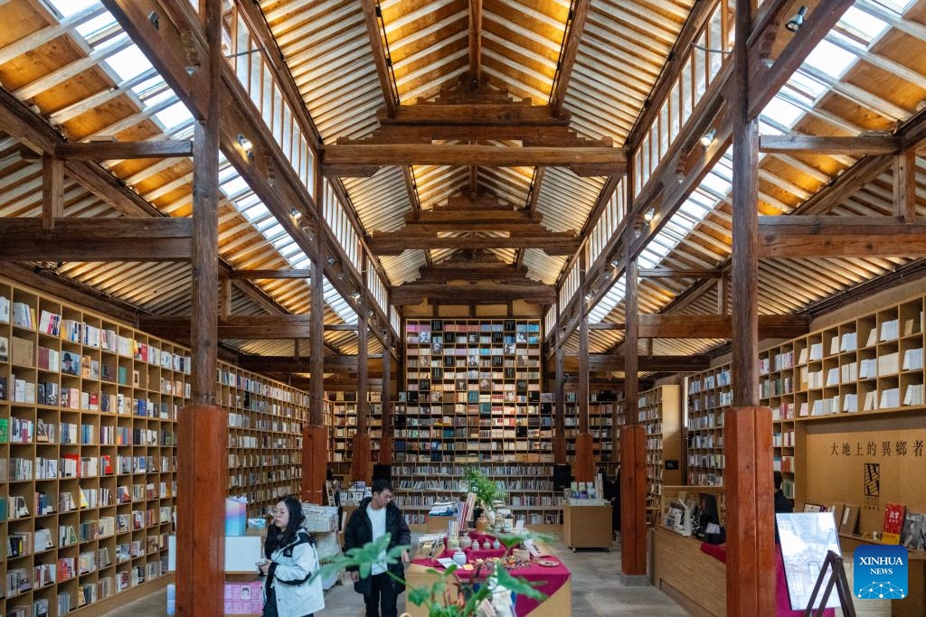 Tourists visit a bookshop in Shaxi Town, Jianchuan County, southwest China's Yunnan Province, March 17, 2025. Shaxi, a remote township in Jianchuan County, was once an important trading hub for tea, herbs, silk and salt on the ancient Tea Horse Road, a trade route dating back to the Tang Dynasty (618-907). The ancient temples, old alleys and caravansaries of the ancient town are reminders of past glories and attract tourists from around the world. (Photo: Xinhua)