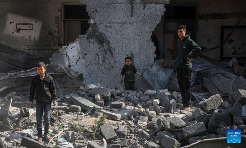 People check the damage of a building in the Shuja'iyya neighborhood, east of Gaza City, on March 18, 2025. The Palestinian death toll from Israeli airstrikes across the enclave early Tuesday has risen to 413, Gaza health authorities reported, adding women and children were among those killed. (Photo: Xinhua)