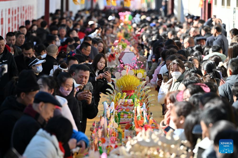 People view dough figurines in Lancheng Township of Lanxian County, north China's Shanxi Province, March 18, 2025. Lanxian dough figurine making was listed as a national-level intangible cultural heritage in 2014. The dough figurines can help revive people's memories of childhood and bear good wishes for the future. (Photo: Xinhua)