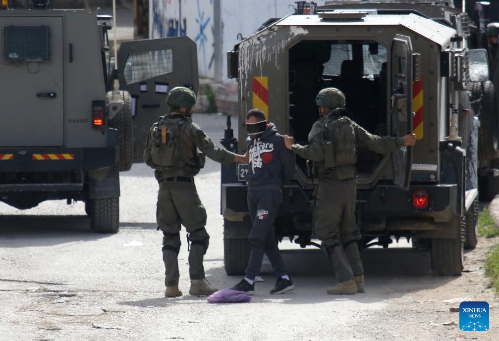 Israeli soldiers detain a Palestinian during a military operation in the Askar al-Jadid camp, east of Nablus in the West Bank, on March 18, 2025. (Photo: Xinhua)