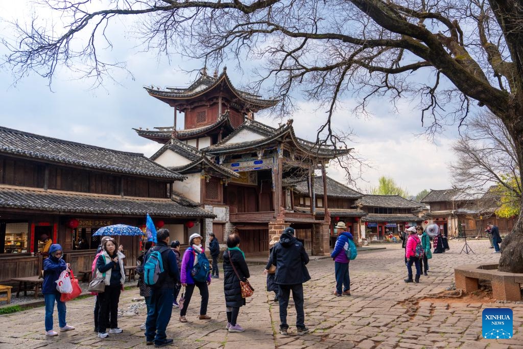 Tourists visit an ancient stage in Shaxi Town, Jianchuan County, southwest China's Yunnan Province, March 17, 2025. Shaxi, a remote township in Jianchuan County, was once an important trading hub for tea, herbs, silk and salt on the ancient Tea Horse Road, a trade route dating back to the Tang Dynasty (618-907). The ancient temples, old alleys and caravansaries of the ancient town are reminders of past glories and attract tourists from around the world. (Photo: Xinhua)