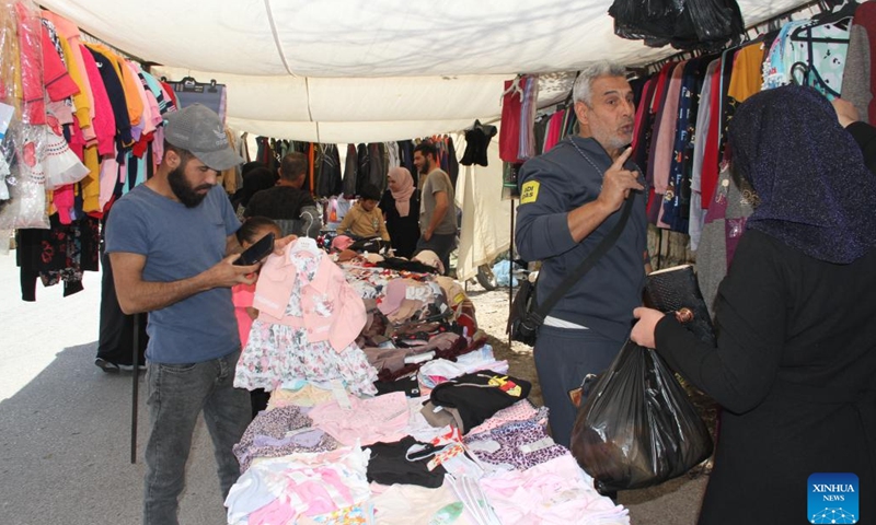 People shop at the Khan market in southern Lebanon's Hasbaya on March 18, 2025. Lebanese citizens and displaced Syrians shop for Eid clothes and other stuff at the Khan market during Ramadan. The market offers second-hand clothing at affordable prices, making it a vital shopping destination for low-income families. (Photo: Xinhua)