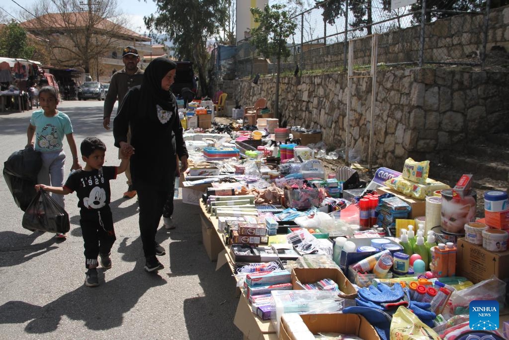 People shop at the Khan market in southern Lebanon's Hasbaya on March 18, 2025. Lebanese citizens and displaced Syrians shop for Eid clothes and other stuff at the Khan market during Ramadan. The market offers second-hand clothing at affordable prices, making it a vital shopping destination for low-income families. (Photo: Xinhua)