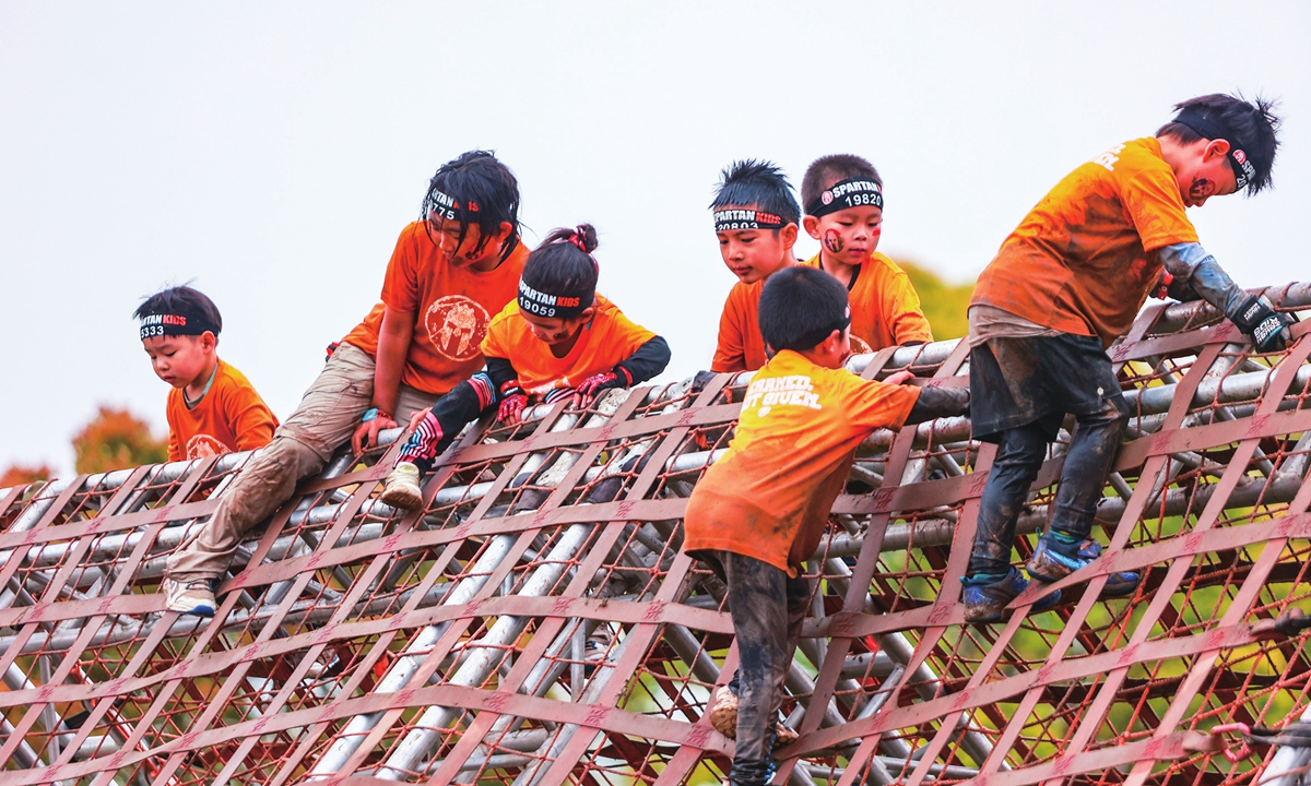 Children navigate obstacles during a Spartan race at Shanghai Binhai Forest Park. Photo: VCG