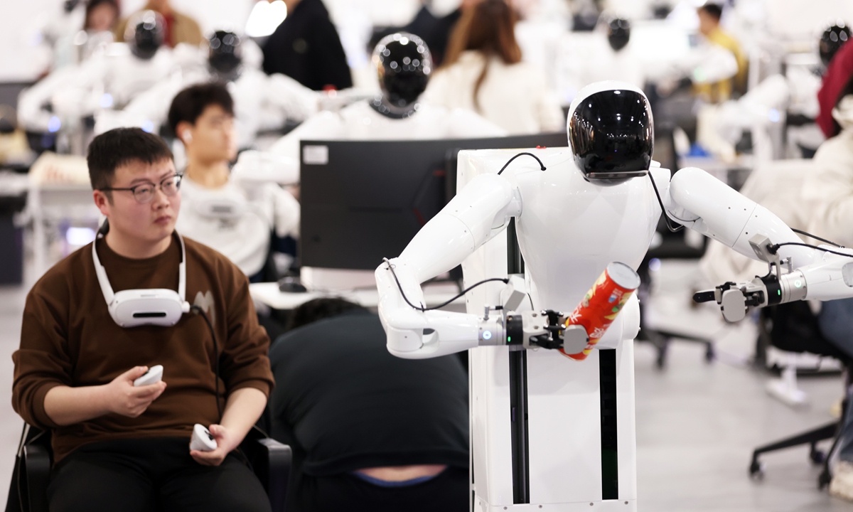 Employees train humanoid robots at an Agibot data collection factory in Shanghai on March 20, 2025.
As of the end of December 2024, China had 451,700 intelligent robotics enterprises with total registered capital of 6.44 trillion yuan ($888.7 billion), data from the State Administration for Market Regulation showed. Photo: VCG