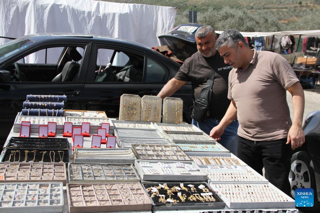 People shop at the Khan market in southern Lebanon's Hasbaya on March 18, 2025. Lebanese citizens and displaced Syrians shop for Eid clothes and other stuff at the Khan market during Ramadan. The market offers second-hand clothing at affordable prices, making it a vital shopping destination for low-income families. (Photo: Xinhua)