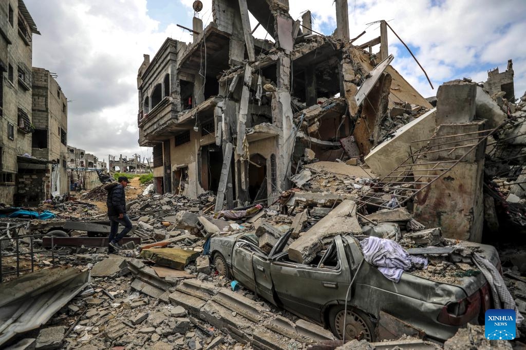A Palestinian man checks a destroyed building after an Israeli airstrike in the northern Gaza Strip town of Beit Lahia, on March 20, 2025. The Israeli military said on Thursday its forces had begun ground operations in northern Gaza, while Hamas' armed wing claimed responsibility for rocket attacks on central Israel, including Tel Aviv, escalating hostilities as a weeks-long ceasefire collapses. Israeli troops began what the military described as ground activity overnight in the Beit Lahia area of northern Gaza, near the coastal border. (Photo: Xinhua)