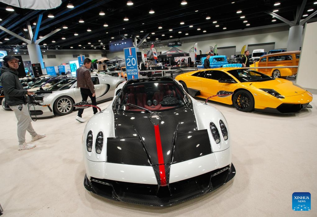Visitors view a Pagani Huayra Roadster during the 2025 Vancouver Auto Show at the Vancouver Convention Centre in Vancouver, British Columbia, Canada, March 19, 2025. Featuring a diverse range of vehicles, from luxury supercars to eco-friendly electric and hybrid models, the annual five-day auto show kicked off here on Wednesday. (Photo: Xinhua)
