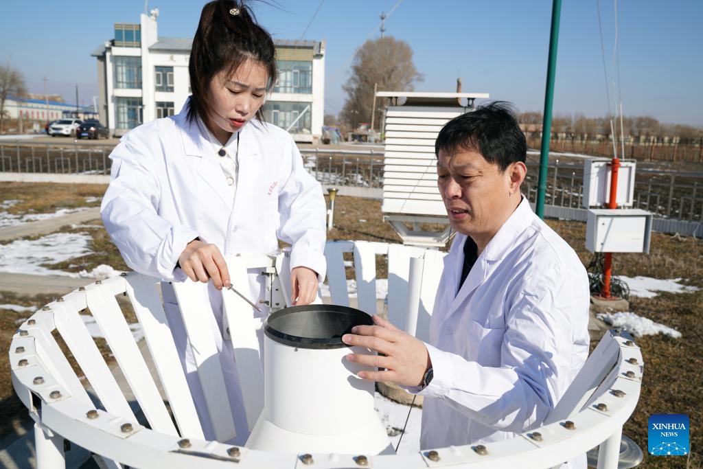 Staff members refill antifreeze in a weighing rain gauge at Youyi Farm Co., Ltd. under Beidahuang Group in Shuangyashan City, northeast China's Heilongjiang Province, March 19, 2025. Farming activities are in full swing across Heilongjiang, China's largest grain producing province, in early spring. (Photo: Xinhua)