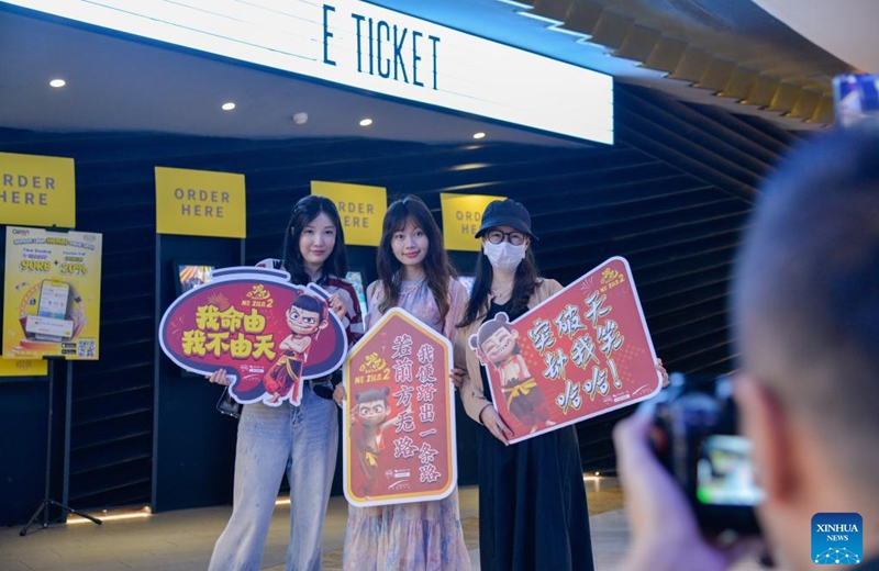 People pose for photos with banners of Ne Zha 2 at a cinema in Jakarta, Indonesia, March 21, 2025. Chinese animated blockbuster Ne Zha 2, the highest-grossing animated film of all time, was officially in cinema in Indonesia on Friday. Photo: Xinhua