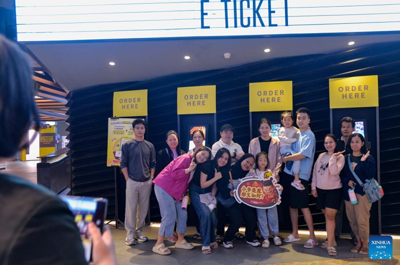 People pose for photos with a banner of Ne Zha 2 at a cinema in Jakarta, Indonesia, March 21, 2025. Chinese animated blockbuster Ne Zha 2, the highest-grossing animated film of all time, was officially in cinema in Indonesia on Friday. Photo: Xinhua