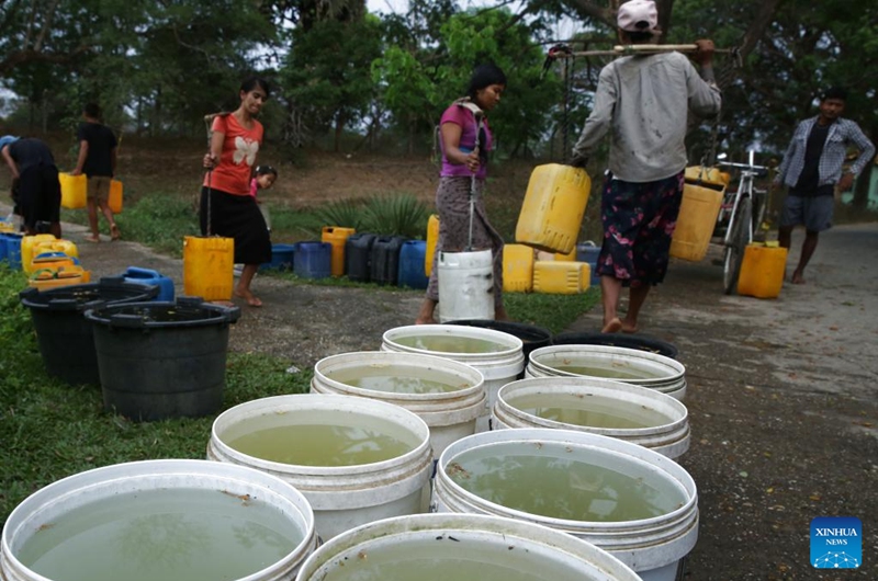 Residents carry water from a lake at Dala Township on the outskirts of Yangon, Myanmar, March 22, 2025. World Water Day is observed around the world on March 22 every year. Photo: Xinhua