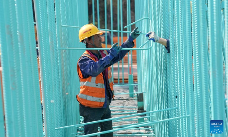 A man works at the construction site of Taoyaomen highway-railway bridge in east China's Zhejiang Province, March 22, 2025. The second layer of concrete pouring for the foundation cap of Pier 5 of the bridge, a crucial cross-sea passage connecting Cezi Island and Fuchi Island of the Zhoushan Islands, was completed on Saturday, marking the transition of the bridge construction into the main tower phase. The 1,531-meter-long bridge, with a main span of 666 meters, serves as a key project of the Ningbo-Zhoushan Railway. Photo: Xinhua