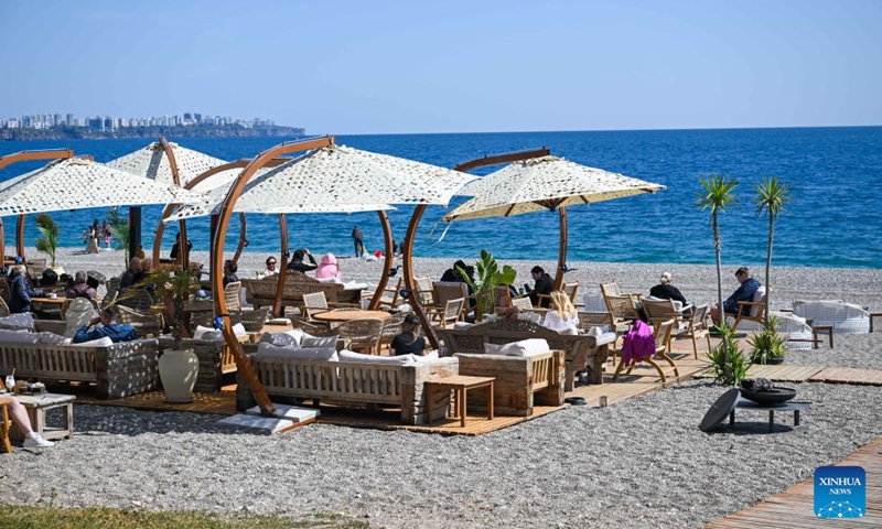 People enjoy leisure time on the beach in Antalya, Türkiye, March 23, 2025. Photo: Xinhua