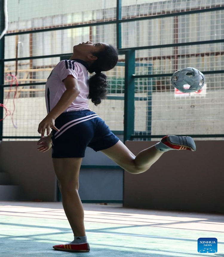 A girl plays Chinlone (caneball) at an indoor stadium in Yangon, Myanmar, March 22, 2025. Photo: Xinhua
