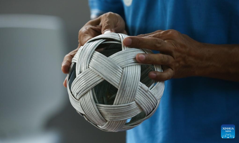 This photo taken on March 22, 2025 shows a man repairing a Chinlone (caneball) at an indoor stadium in Yangon, Myanmar. Photo: Xinhua