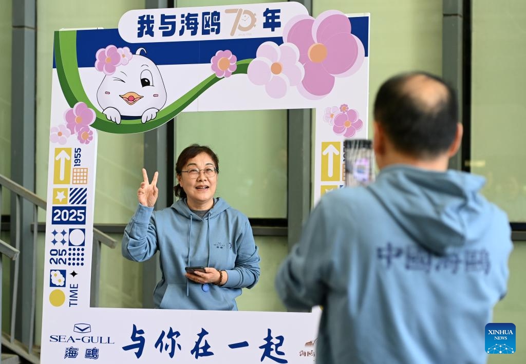 A staff member poses for photos at the company campus of the watch manufacturer SEA-GULL in north China's Tianjin, March 24, 2025. SEA-GULL, a watch manufacturer based in north China's Tianjin, celebrated the 70th anniversary of New China's first domestic watch with various activities on Monday. In 1955, a watch was successfully developed in Tianjin, marking SEA-GULL as the birthplace of the nation's pioneering timepiece. After seven decades of research and development efforts, the company has mastered advanced watchmaking technologies with independent intellectual property rights. (Photo: Xinhua)