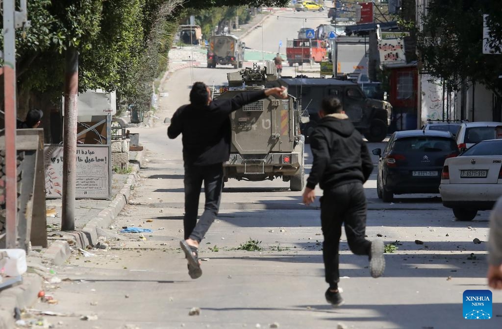 Palestinians confront Israeli forces during clashes in the Balata refugee camp, east of Nablus in the northern West Bank, on March 24, 2025. (Photo: Xinhua)