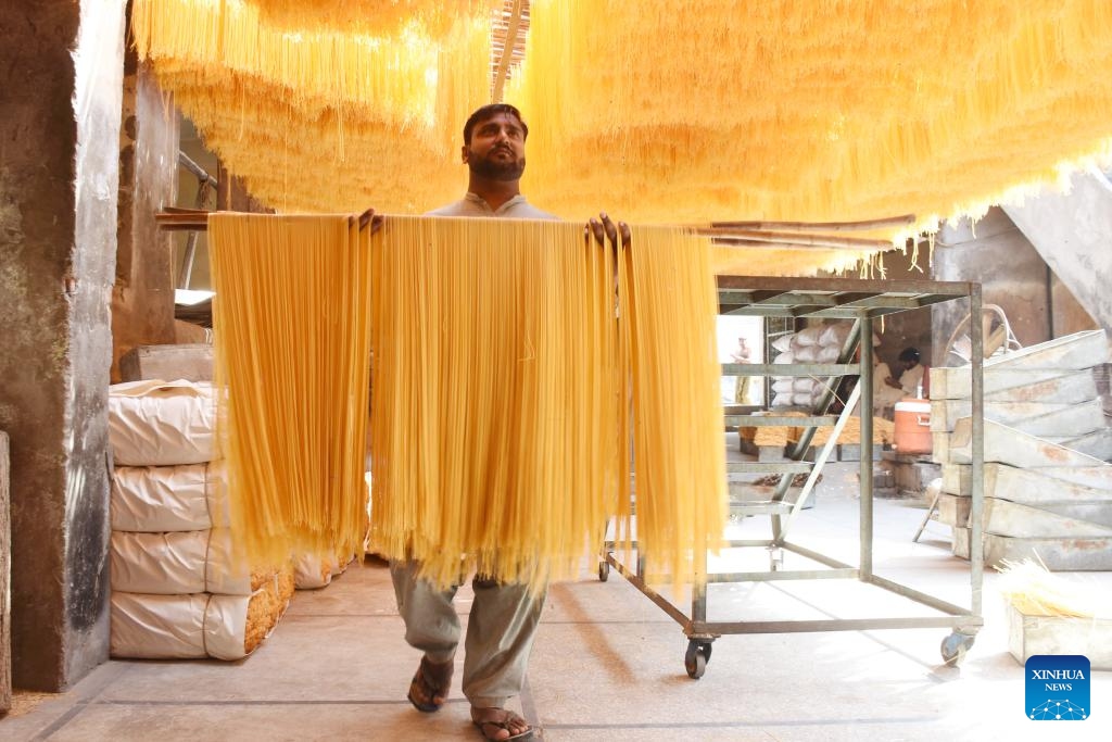 A worker arranges vermicelli noodles at a factory in Lahore, Pakistan, March 25, 2025. The vermicelli noodle is popularly used for breaking fast during holy month of Ramadan in Pakistan. (Photo: Xinhua)