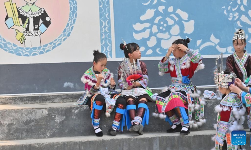 Students prepare for a performance at a primary school in Rongshui Miao Autonomous County of Liuzhou City, south China's Guangxi Zhuang Autonomous Region, March 25, 2025. Students of various ethnic groups at a primary school in Rongshui held a celebration prior to the Sanyuesan Festival, a festival celebrated on the third day of the third lunar month, by wearing traditional costumes and staging traditional performances on Tuesday. This year's Sanyuesan Festival falls on March 31. (Photo: Xinhua)