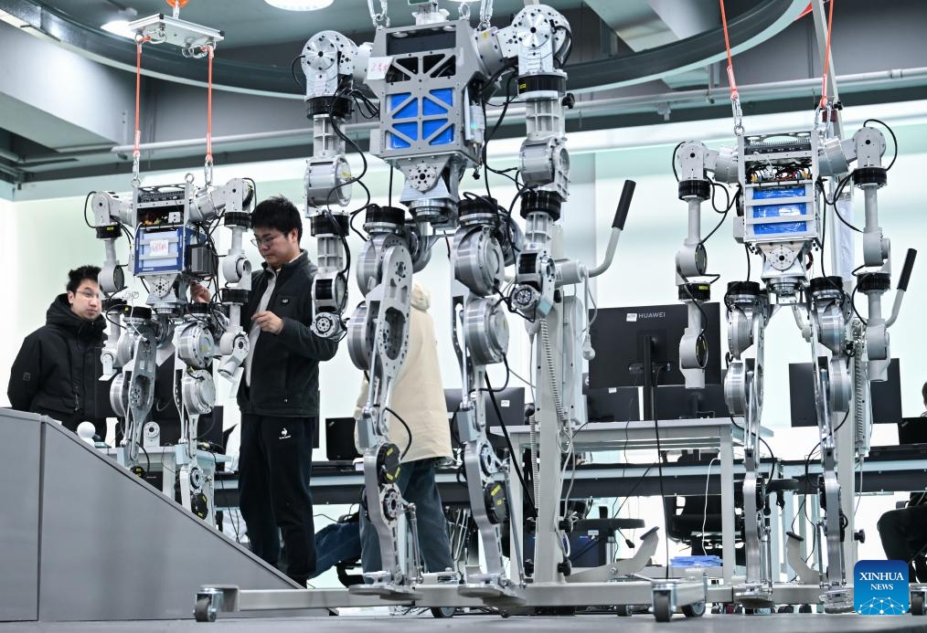 Members of the R&D team of Wuhan Glory Road Intelligent Technology Co., Ltd. debug a humanoid robot at the company in Wuhan, central China's Hubei Province, Feb. 24, 2025. In recent years, Hubei Province has strengthened the introduction and training of scientific and technological innovation subjects and promoted the development of humanoid robot industry. (Photo: Xinhua)