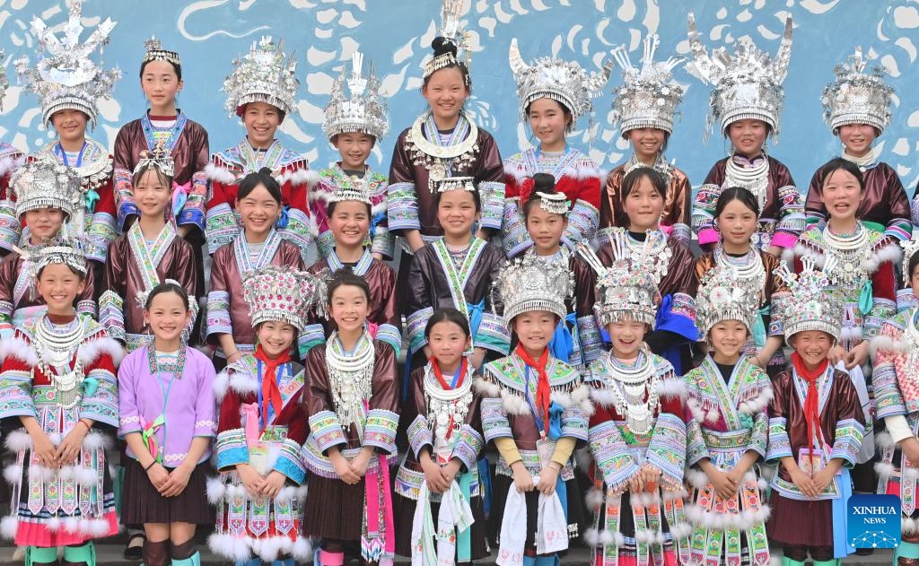 Students pose for a group photo at a primary school in Rongshui Miao Autonomous County of Liuzhou City, south China's Guangxi Zhuang Autonomous Region, March 25, 2025. Students of various ethnic groups at a primary school in Rongshui held a celebration prior to the Sanyuesan Festival, a festival celebrated on the third day of the third lunar month, by wearing traditional costumes and staging traditional performances on Tuesday. This year's Sanyuesan Festival falls on March 31. (Photo: Xinhua)