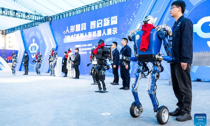 Humanoid robots show up at a conference on promoting the rise of China's central region in Wuhan, central China's Hubei Province, Feb. 5, 2025. In recent years, Hubei Province has strengthened the introduction and training of scientific and technological innovation subjects and promoted the development of humanoid robot industry. Relying on strong scientific research capacity and industrial foundation, Hubei Province has organized many universities, research institutes and enterprises in the province to carry out scientific research of humanoid robots and explore the application scenarios. (Photo: Xinhua)