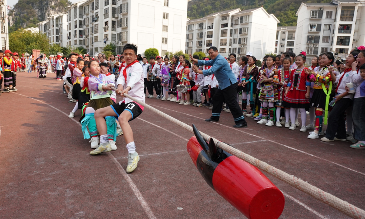 Students from various ethnic groups, such as Miao, Yao, Dong, Zhuang and Han, participate in the Miao ethnic drum-pulling competition at a primary school in the Rongshui Miao autonomous county, South China's Guangxi Zhuang Autonomous Region on March 26, 2025. The event was held to celebrate the upcoming Sanyuesan Festival on the third day of the third month of the Chinese lunar calendar, which falls on March 31 this year. Photo: IC