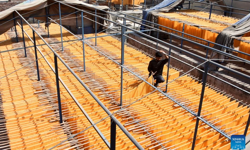 A worker arranges vermicelli noodles at a factory in Lahore, Pakistan, March 25, 2025. The vermicelli noodle is popularly used for breaking fast during holy month of Ramadan in Pakistan. (Photo: Xinhua)