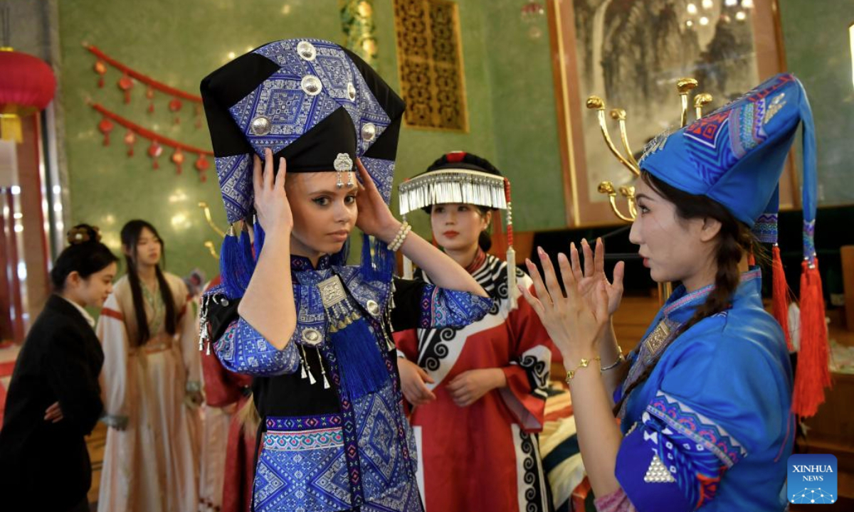 Students try Chinese ethnic costumes at the 2025 International Chinese Language Day event in Moscow, Russia, April 20, 2025. (Photo by Alexander Zemlianichenko Jr/Xinhua)