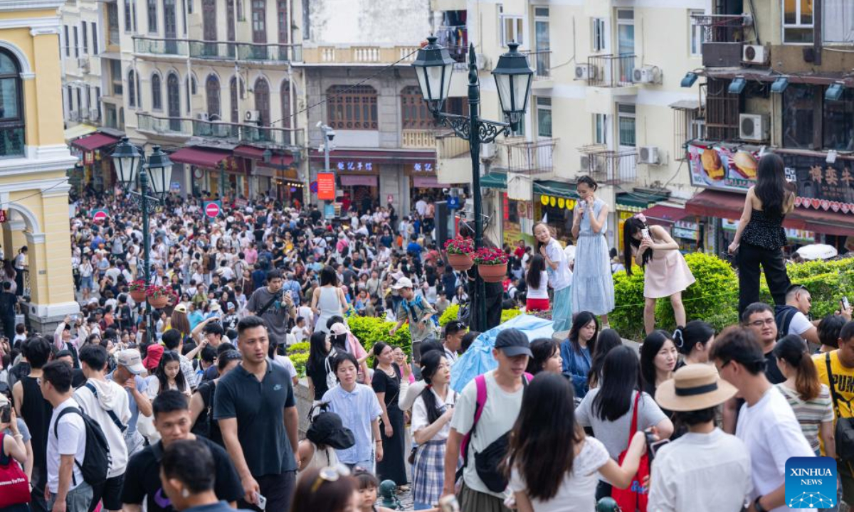 Tourists are pictured near the Ruins of St. Paul's in south China's Macao, May 3, 2025. The first three days of China's May Day holiday saw a significant influx of visitors to the Macao Special Administrative Region (SAR), injecting new vitality into the local tourism industry.

Statistics from the SAR's Public Security Police Force (CPSP) showed that from Thursday to Saturday, Macao's border checkpoints recorded entries and exits of 731,474, 837,062, and 826,273, respectively. Friday experienced the highest daily total, including 221,968 incoming visitors, marking the highest single-day record for inbound tourists since the pandemic.(Xinhua/Cheong Kam Ka)