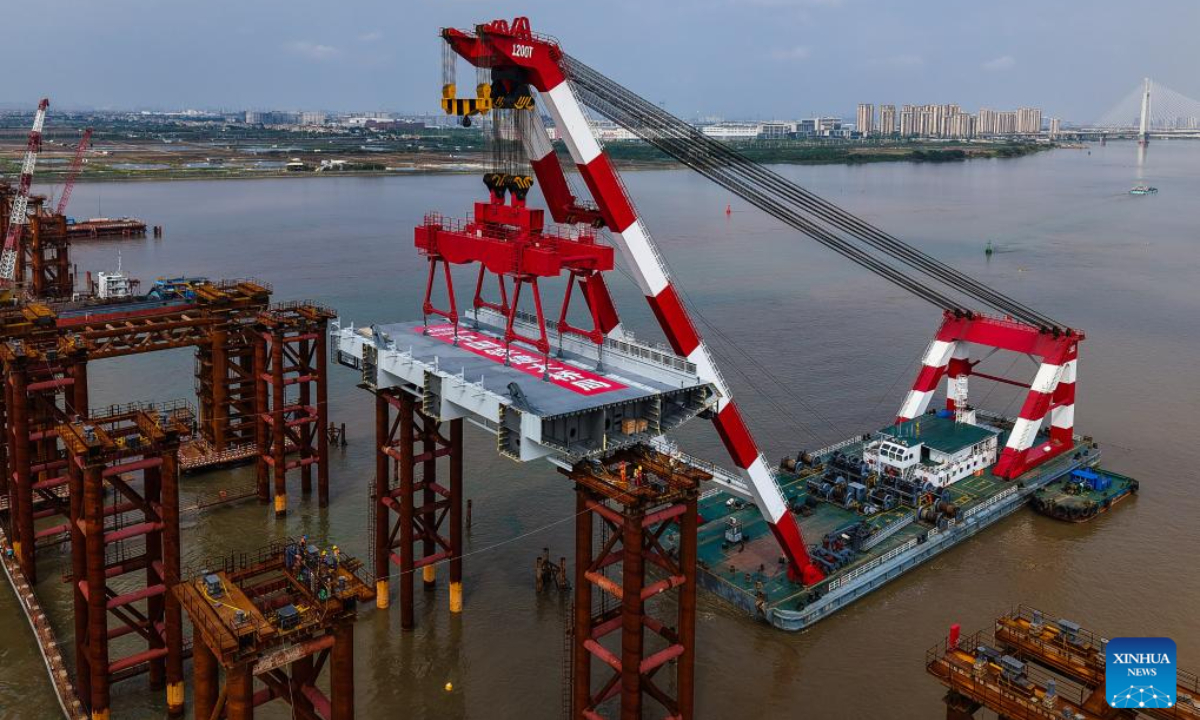 An aerial drone photo taken on April 29, 2025 shows the setting scene of the first steel box girder of Wanlong Grand Bridge in Nansha District of Guangzhou, south China's Guangdong Province. The first steel box girder of Wanlong Grand Bridge, with a length of 5,146 meters, a main bridge of 1,150 meters and a main span of 608 meters, was successfully set on Tuesday. The bridge, located at Guangdong-Hong Kong-Macao Greater Bay Area, is the world's largest-span self-anchored suspension bridge. Photo:Xinhua