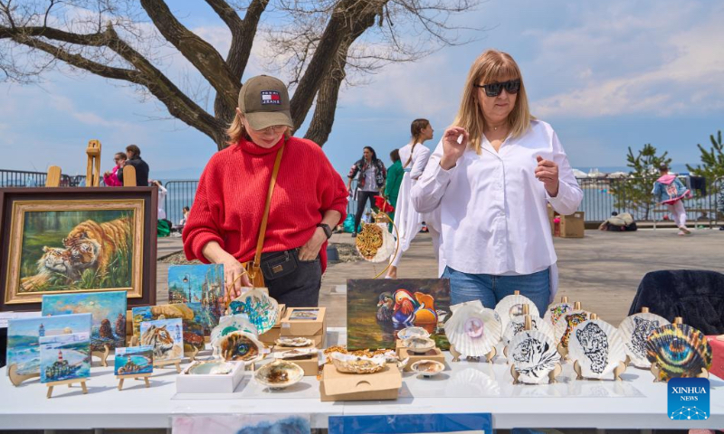 Two women display handicrafts during a 