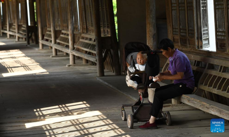 Residents enjoy leisure time in the Gongbei roofed bridge in Xiuning County of Huangshan City, east China's Anhui Province, May 15, 2024. Roofed bridge, also called covered bridge, is a unique architectural structure in Huangshan City. These ingeniously structured and elegantly shaped bridges carry rich cultural significance and form a distinctive part of Huizhou culture.

In recent years, the city of Huangshan has promoted the inheritance and development of roofed bridge culture through conservation projects, revitalization efforts, and promotional campaigns, attracting an increasing number of visitors to experience the allure of these ancient architectural marvels. (Xinhua/Zhang Duan)